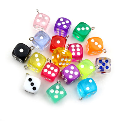 translucent multicolor dice charms arranged together on a white background