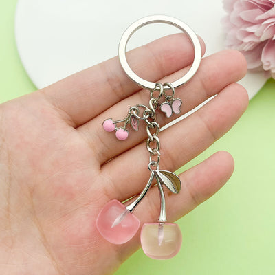 Image 1 showing a person holding up two pink flowers.