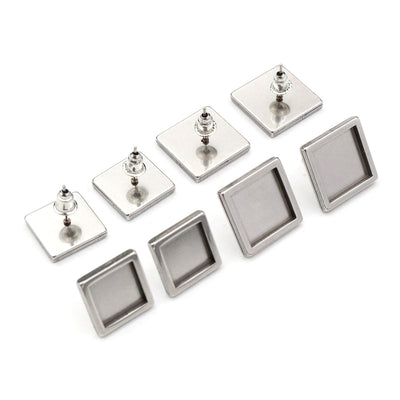 Assorted square earring post bezel blanks in a silver tone arranged together on a plain background