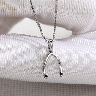 Product view showing minimal polished silver-tone wishbone pendant necklace