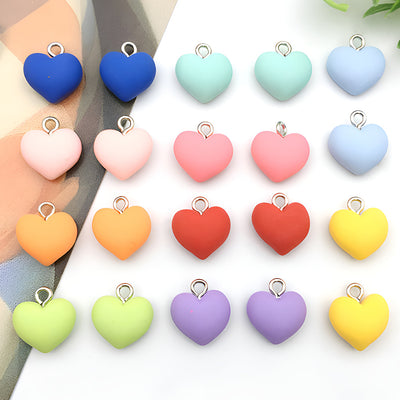 Colorful heart charms arranged on a light background