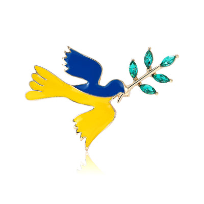 Front view of flying blue and yellow dove carrying an olive branch