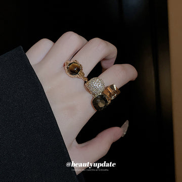 Three Mixed Statement Rings With Brown Crystals Green Or Brown Stones