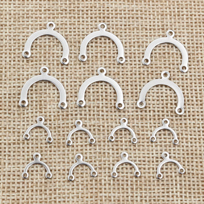 three loop arched metal connector findings arranged together on a white background