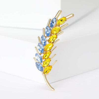 Front view of blue and yellow crystal wheat stalk brooch in gold tone