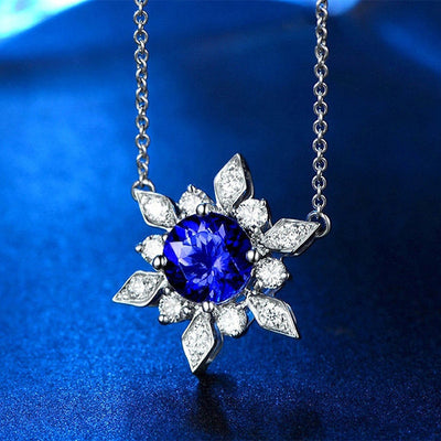 Front view of blue round crystal floral pendant necklace in silver tone