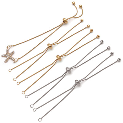 Gold-tone adjustable slider chain jewelry findings arranged on a light background