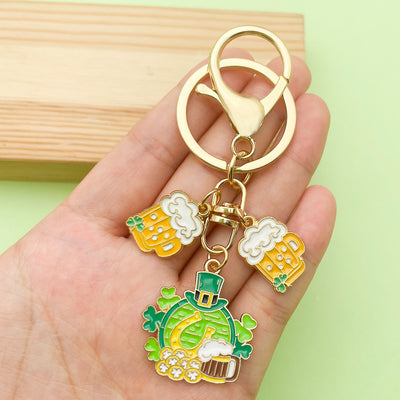 Image 1 showing a hand holding a keychain with some charms.