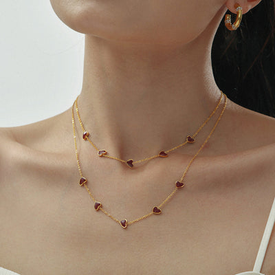 Model layered two burgundy heart station gold necklaces