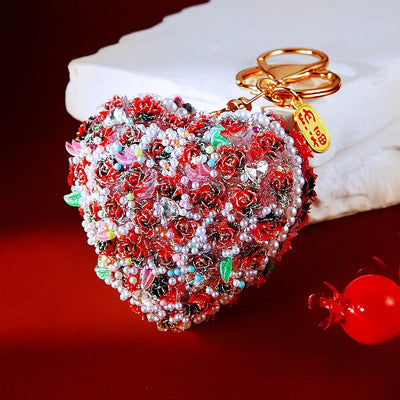 A styled front view shows the rose texture heart keychain and its attached hardware.