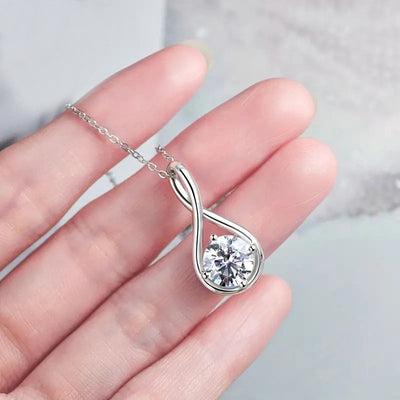 Silver teardrop twist crystal pendant necklace held in open palm