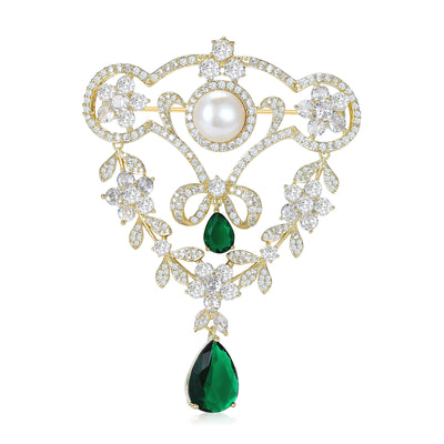 Front view of ornate Floral Crystal Brooch With Pearl and Green Drops against a white background.