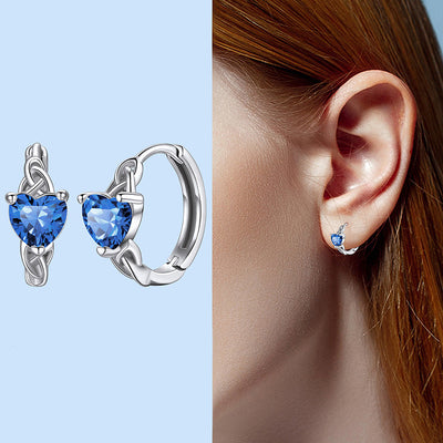 Deep blue heart CZ silver huggie hoops product shot and worn on ear