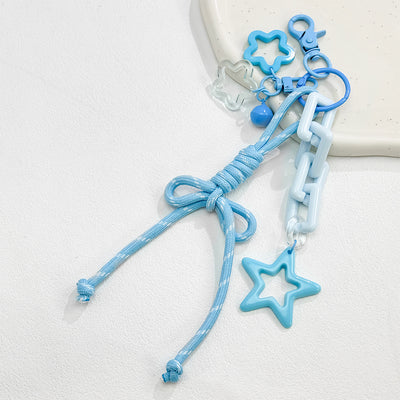 Sky blue woven cord bow keychain with star and flower charms and a small bell