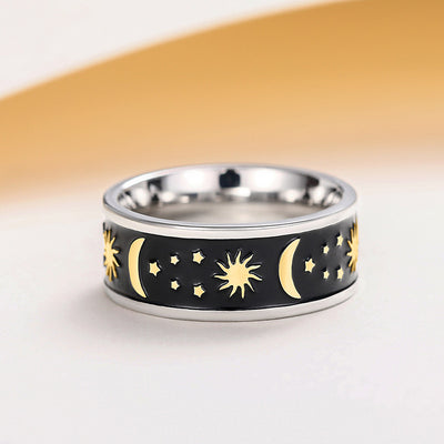 Two-tone steel and gold celestial band ring with black inlay sun moon stars