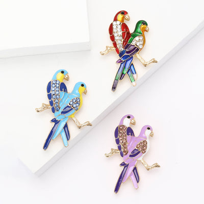 Pair of Enamel Parrots Brooch shown from the front on a white background