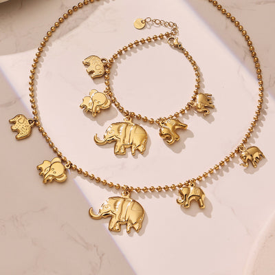 Gold elephant charm ball chain necklace and bracelet flat lay
