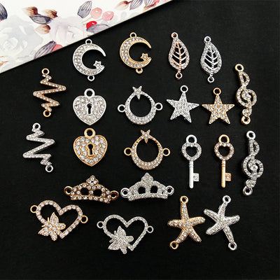Black crown and starfish charms arranged on a light background