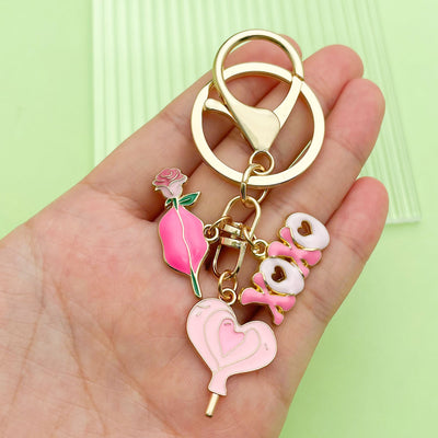 Image 1 showing a person holding two key chains in their hand.