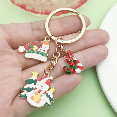 Image 1 showing a hand holding two christmas themed key chains.