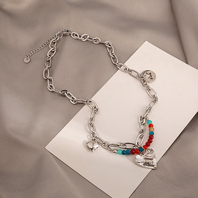 Silver chain heart multicolor bead necklace on white card and fabric