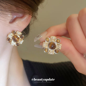 Gold Tone Brown Cabochon Floral Stud Earrings With Decorative Metal Accents