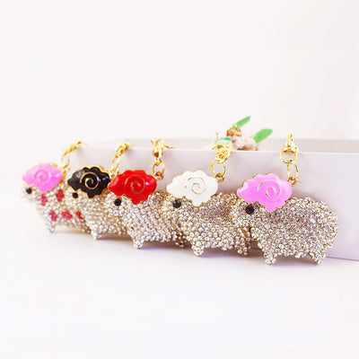 Five rhinestone sheep keychains displayed with pink, black, red, and white spiral horns.
