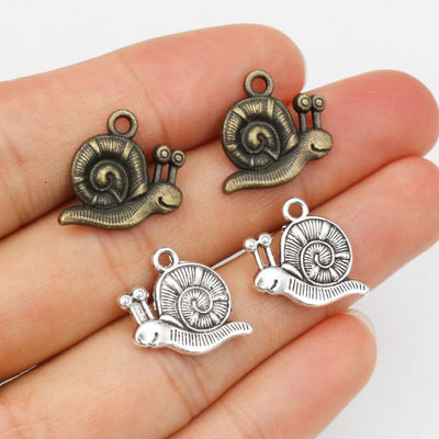 sculpted snail charm assortment on a light background