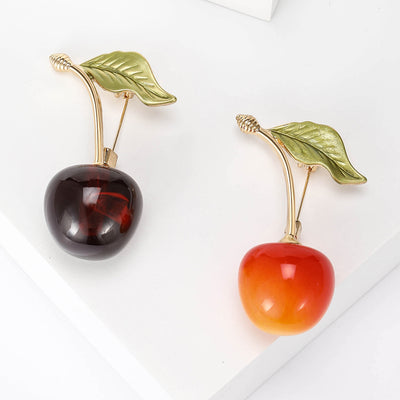 Cherry Brooch with Green Leaf in Two Red Shades displayed from the front