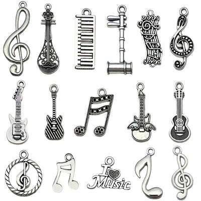 Antique silver guitar charms arranged on a light background