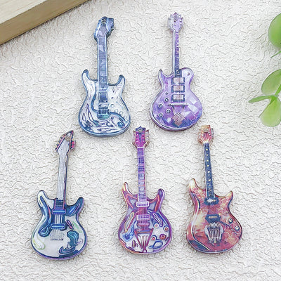 Colorful guitar charms arranged on a light background