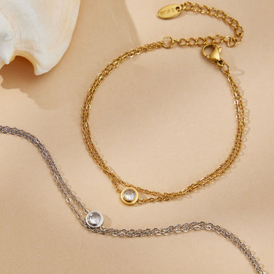 Gold and steel double chain zircon bracelets on sand