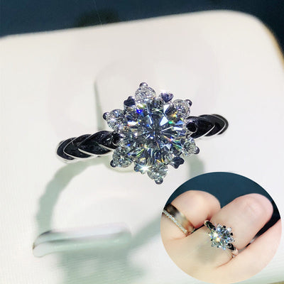 Front view of round crystal floral ring with twisted silver tone band