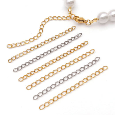 Gold-tone extender chain jewelry findings arranged on a light background
