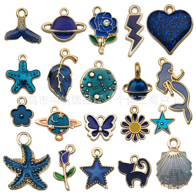 Colorful mermaid and starfish charms arranged on a light background