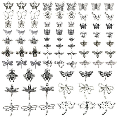 Metallic butterfly and bee charms arranged on a light background