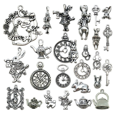 Antique silver rabbit charms arranged on a light background