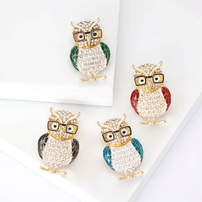 Crystal Owl Brooch With Colored Enamel Wings and Glasses shown from the front on a white background