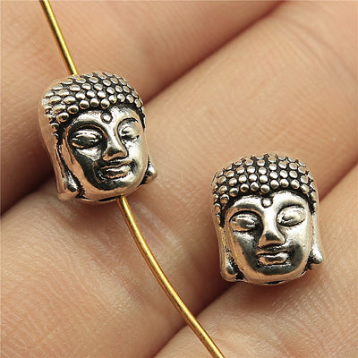Close view of the buddha head bead showing serene face and dotted hair texture