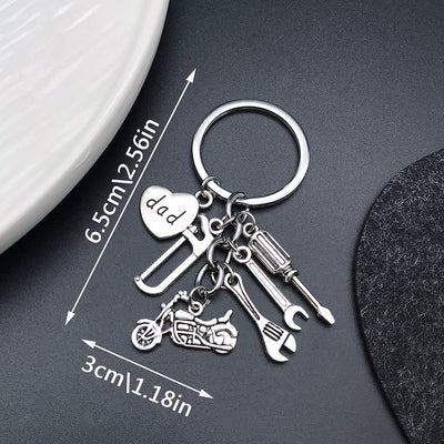 Front product photo of antique silver motorcycle tool saw wrench and heart charm keychain showing the pictured design ar
