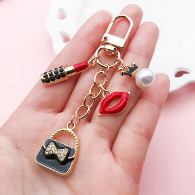 Image 1 showing a person holding up some keys and charms.