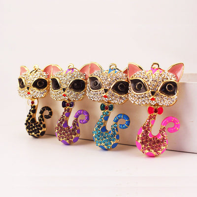 Four rhinestone cat charms in black, purple, blue and pink color accents.
