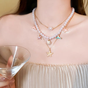 Gold Tone Three Piece Layered Coastal Charm Necklace Set