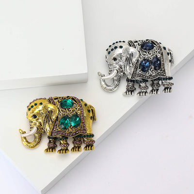 Front view showing the antique gold elephant brooch with green and blue crystal accents