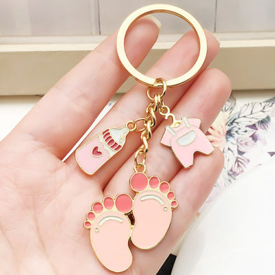 Overview showing the available color and design variations of the pink baby outfit and footprint metal keychain