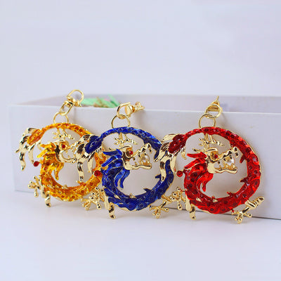 Three round dragon ornaments in gold, blue, and red stand side by side.