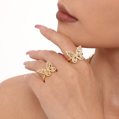 Model wearing two gold zircon butterfly open rings near face