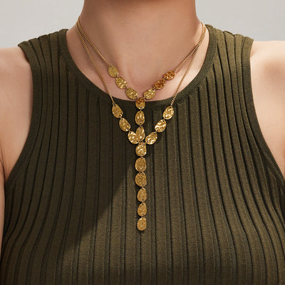 Gold hammered disc Y necklace layered with thin chain on olive top