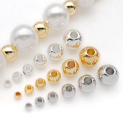 Front overview of round seamless straight hole metal beads arranged by finish and size