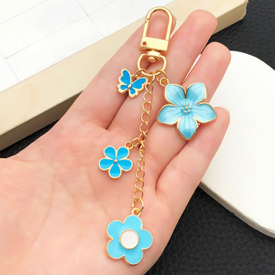 Overview showing the available color and design variations of the blue and pink cherry blossom butterfly clasp keychain